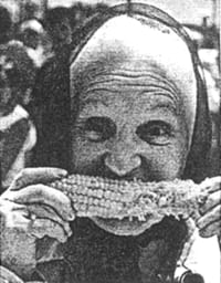 black and white of women eating corn on the cob
