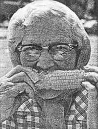 black and white of a woman eating corn on the cob