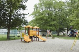 Empty playground with slides and swings in park.