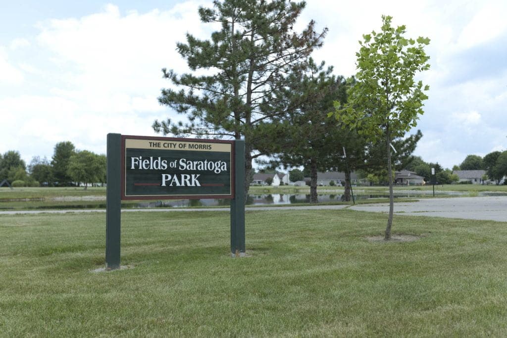 Park sign &quot;Fields of Saratoga&quot; in Morris, with trees.