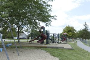 Suburban playground with swings and slides