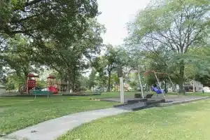 Quiet playground with swings and slide in park.